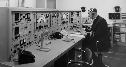 The radio console of the 'Rotterdam' (call sign PHEG) with Radio Officer Jan de Bock.